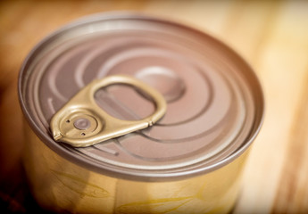 Tin on a wooden board in a kitchen