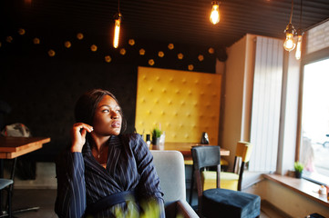 African american businesswoman sitting at table in cafe. Black girl having rest.