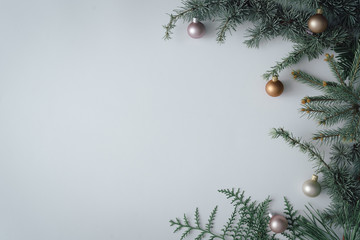 Christmas tree branch with colorful baubles decoration. Minimal creative flat lay. New Year Christmas background concept.