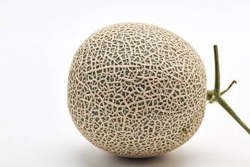 Single cantaloupe melon on white