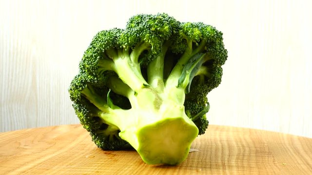 Shooting of broccoli in the movement.	Cuttig board.