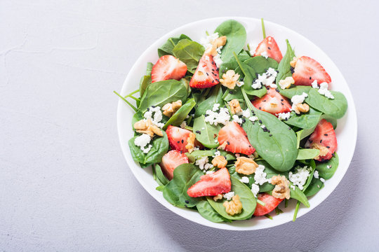 Strawberry salad with spinach , cheese and walnut