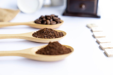 close up crushed coffee bean on wooden spoon