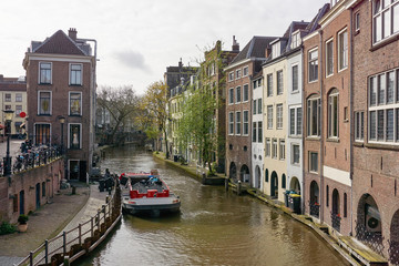 View on canal and houses in Utrecht The Netherlands with garbage collection service by boat 