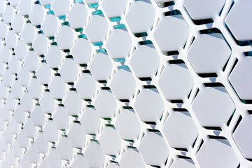 Geometric open metal pattern with white tilted hexagonal shapes  