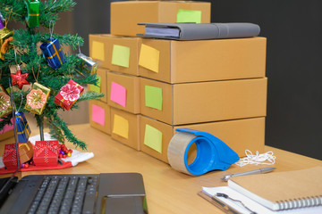 parcel cardboard box at business owner workplace during christmas. Online selling, e-commerce concept