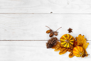 Autumn leaf with decorative pumpkins composition on old white vintage wooden texture floor. Fall,...