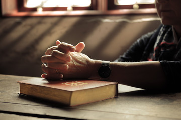 Woman with bible praying