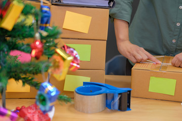 Fototapeta na wymiar startup business owner packing cardboard box. man seller prepare parcel box for delivery. Online selling, e-commerce concept