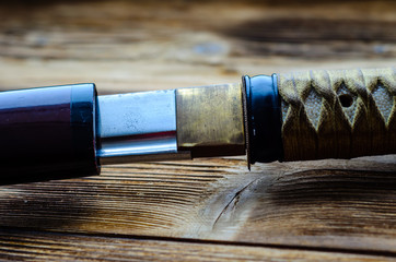 Japanese sword katana on wooden background