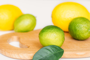 lemon, lime and mint on a wooden board 