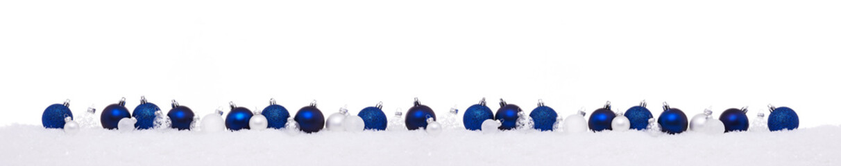 Blue and white Christmas balls in a row isolated on snow, Christmas banner