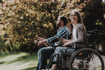 People on Wheelchairs with Fishing Rod in Park.