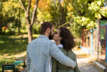 Fototapeta premium love, relationship, family and people concept - smiling couple kissing in autumn park