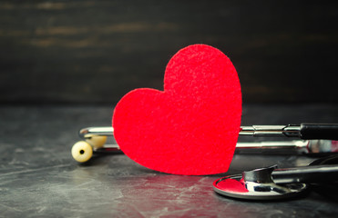 Red heart and stethoscope. The concept of medicine and health insurance, family, life. Ambulance. Cardiology Healthcare.
