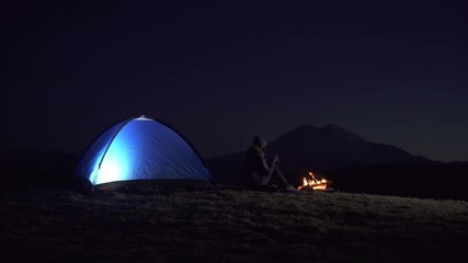 traveler at the tent with campfire