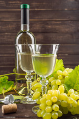 Fototapeta na wymiar Wine bottle and grape on wooden table