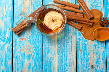 Cup with aromatic hot cinnamon tea on wooden table