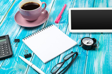 Modern workplace with cup of coffee on wooden table
