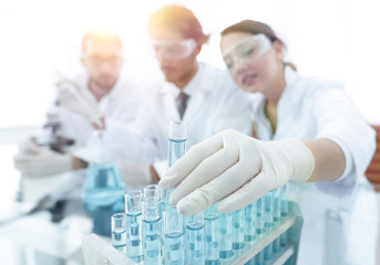 Scientist holding test tube or some equipment of science