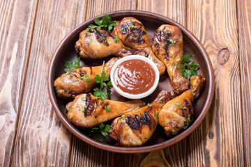 Fototapeta premium Grilled chicken legs with tomato sauce