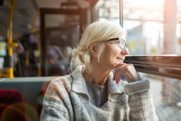 Senior woman looking through bus window