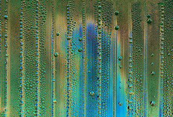 abstract background with big and small water drops in different colors - acid green and copper with blue colors