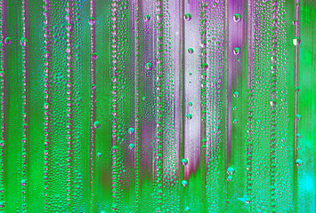 abstract background with big and small water drops in different colors - acid green with violet