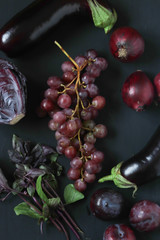 red and purple foods on a black background