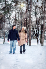 Fototapeta na wymiar Happy Couple in Winter Park having fun. winter holidays, Christmas and people concept –.