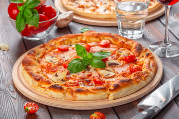 Delicious fresh pizza served on wooden table