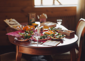 Champagne and snacks on a wooden table. Festive reception on occasion. Homemade Feast. Blur. Bokeh.