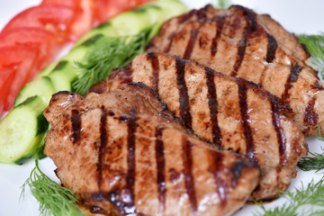 Grilled meat. Restaurant dish. Steak with vegetables.