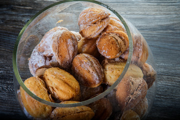 closeup handmade baked nuts with boiled condensed milk in glass jar