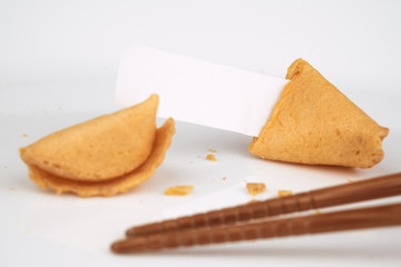 CRACKED FORTUNE COOKIE WITH WHITE BLANK SLIP PAPER FOR ADD TEXT OR MESSAGE