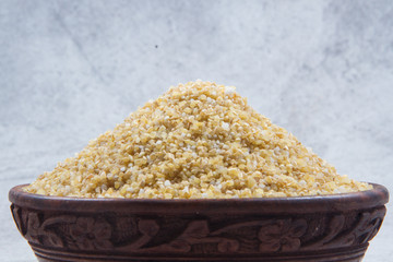 bulgur seeds isolated on texture background