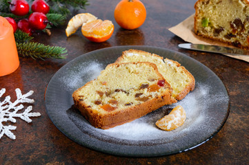 Christmas cake with nuts, dried fruit, tangerines. Traditional festive pastries.