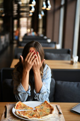 Girl in a cafe with pizza