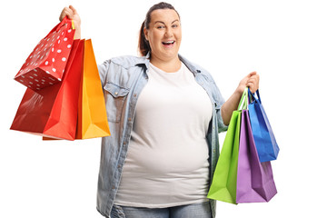 Happy plus size woman holding shopping bags