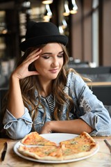 Girl in a cafe with pizza