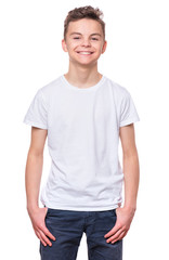 White t-shirt on teen boy. Handsome caucasian smiling child, isolated on a white background. Concept of childhood and fashion or advertisement design. Mock up template for design print.