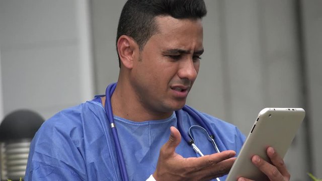 Confused Hispanic Male Surgeon With Tablet