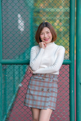 Portrait of beautiful asian woman wear skirt at tennis course,Pose for take a picture,Thailand people,Lifestyle of modern girl