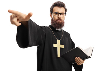 Priest holding a bible and pointing