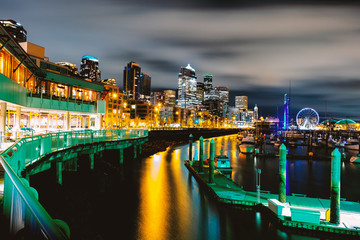 Fototapeta na wymiar Seattle waterfront at night light,waterfront and skyline night light with a marina and ferris city background,Seattle pier-66 waterfront view with urban architecture at night