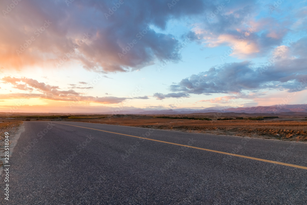 Wall mural road with sunset glow