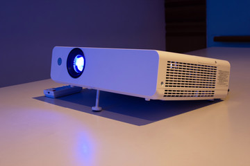 projector for presentation in a meeting room (Light in a light yellow tone room.)