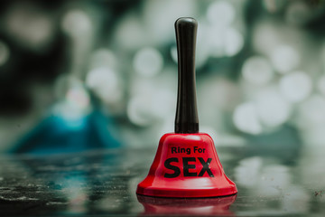 Sex toy. Sex toys. Bell. Bokeh background. Sensual.  - obrazy, fototapety, plakaty