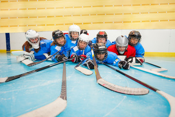 Naklejka premium Happy hockey team laying on ice rink at stadium