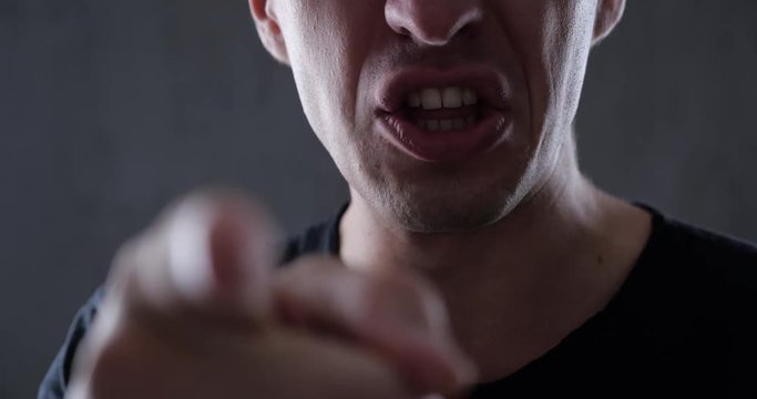 Closeup Man Speaks Aggressively and Threatens with his Finger. Danger Violence. To force, compel, dominate. 4K 10-bit